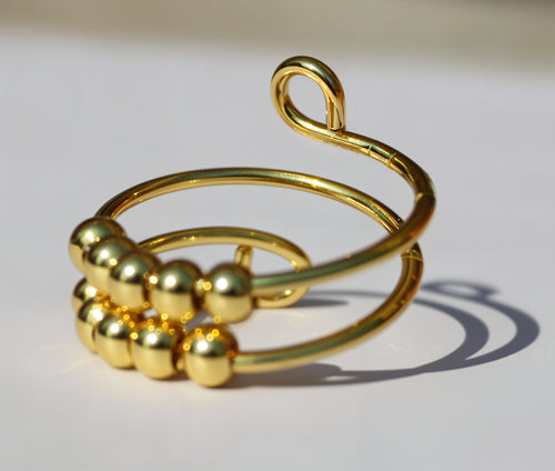 Pierścionek antystresowy w złotym kolorze z obrotowymi kulkami - regulowany