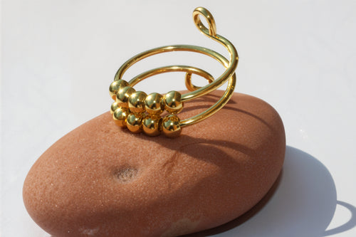 Pierścionek antystresowy w złotym kolorze z obrotowymi kulkami - regulowany